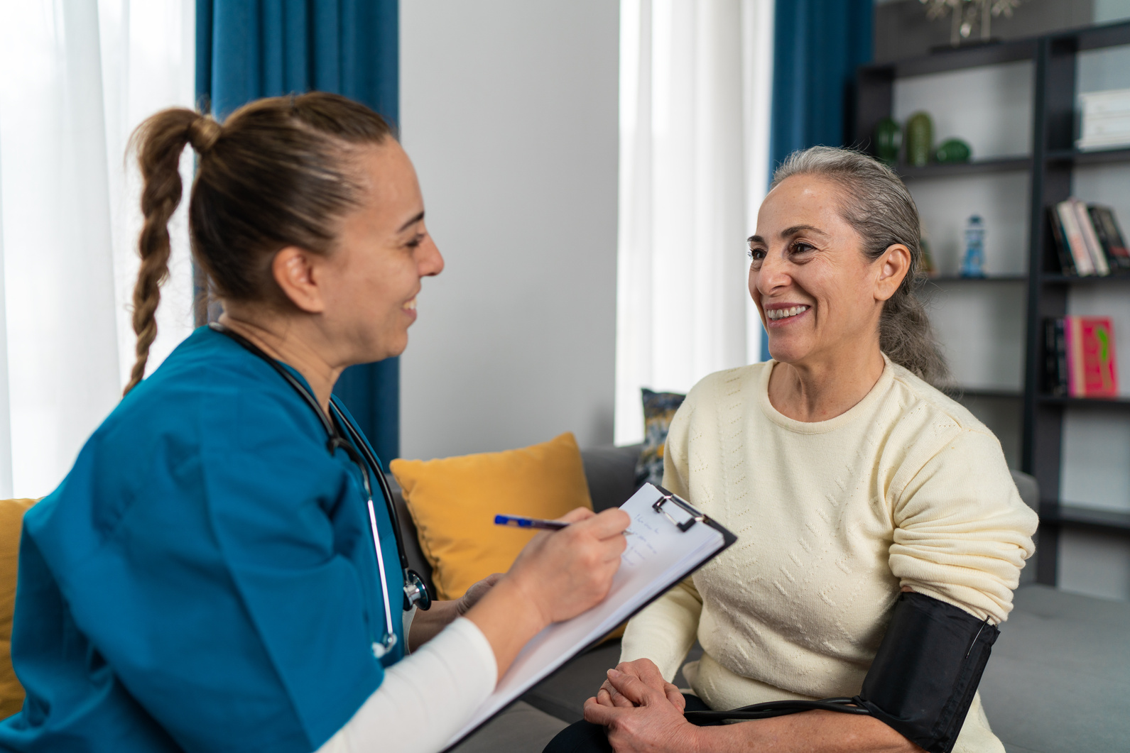 Home health nurse providing care for patient